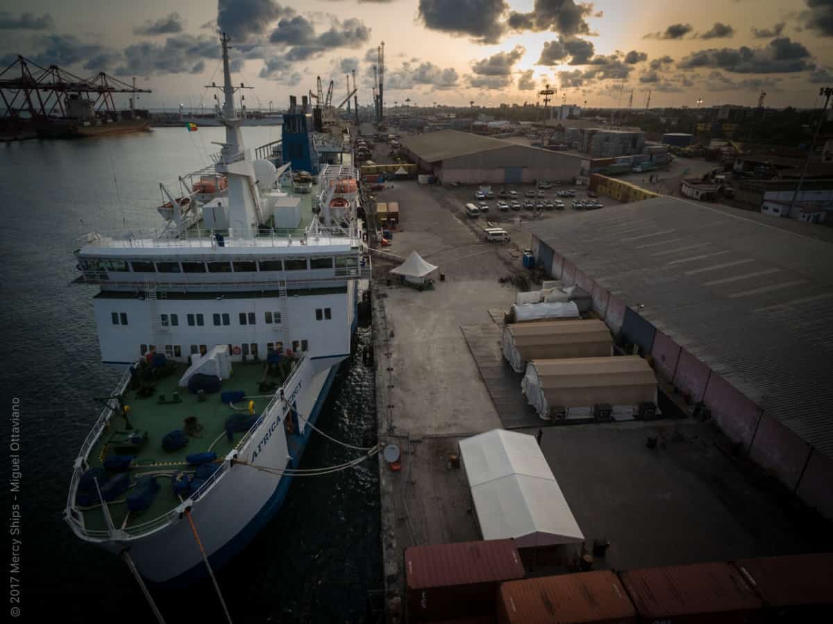 The Africa Mercy as the sun sets over the port of Cotonou, Benin 2017.