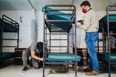 Griffin Smith and Werner Neuschwanger, Biomedical Project Assistants, assembling beds in the LCU.